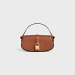 CLUTCH ON STRAP TABOU IN SMOOTH CALFSKIN TAN